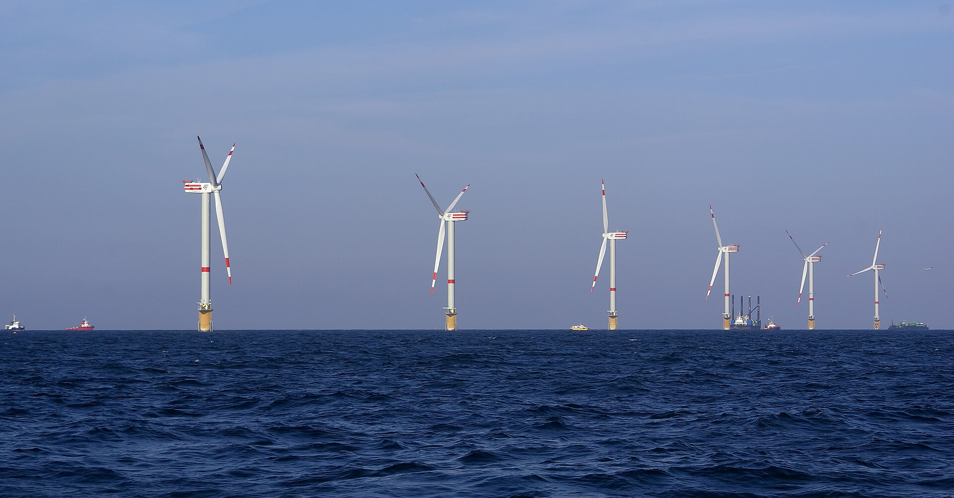 Wind turbines of the offshore wind farm on the Thornton Bank in the North Sea, under a grey-blue sky