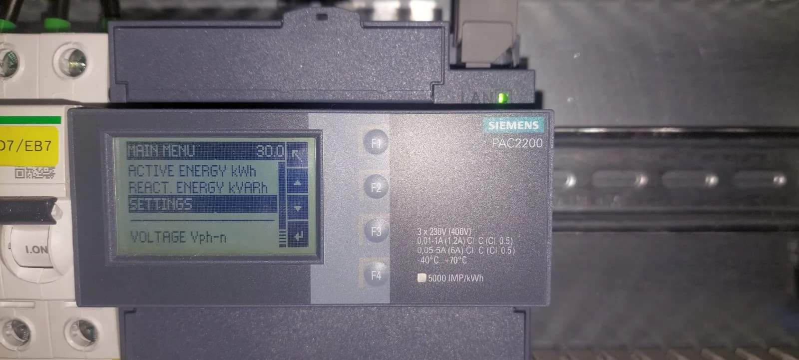 Het hoofdmenu van de PAC2200 met Settings uitgelicht, onder Active energy en Reactive energy.
