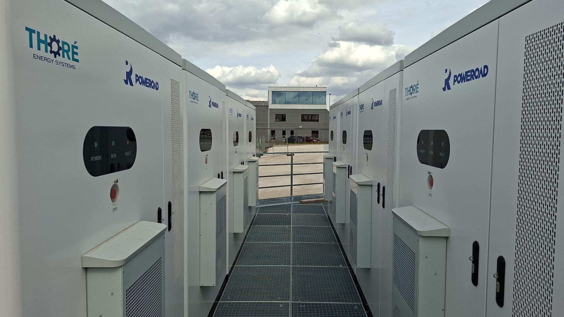 Row of eight Poweroad battery containers at the transport company site