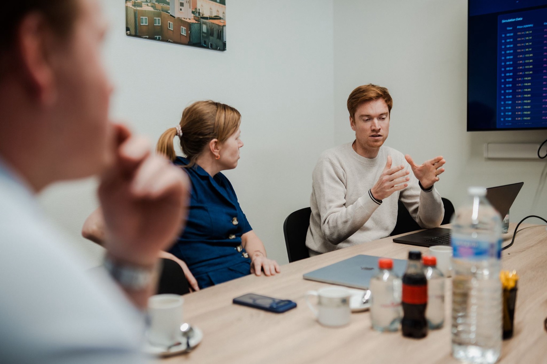 The Voltmasters team in a meeting with a partner, with simulation data on the screen